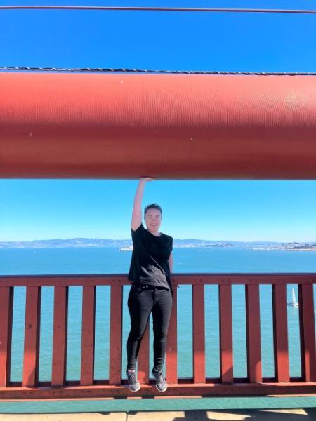 A photograph of Jennifer at the mid-span of the Golden Gate bridge in San Fransisco – demonstrating how think the cables are.